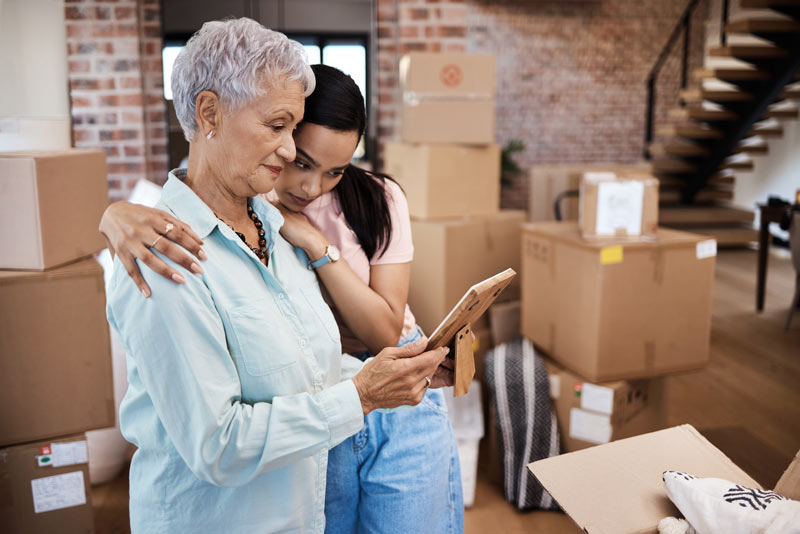 Elderly lady and younger woman looking at a phone