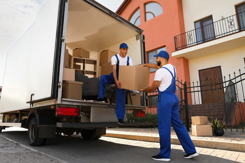 Stock Image of Men Working on a Removals Van