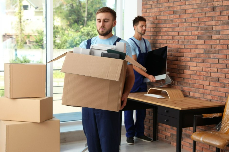 Worker removing boxes from office